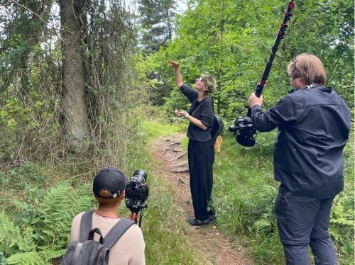 Behind the scenes, Take Two crew filming with an artist