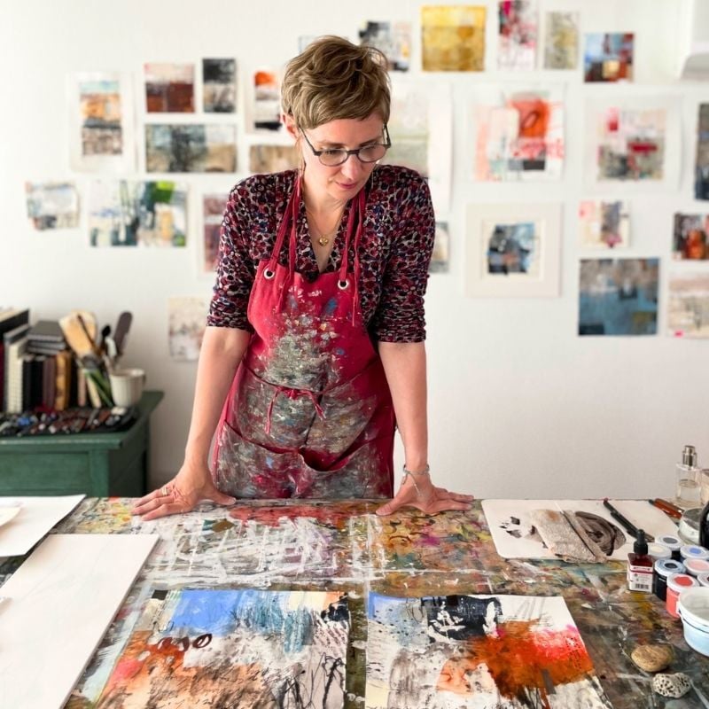 Eva Kalien standing at her desk
