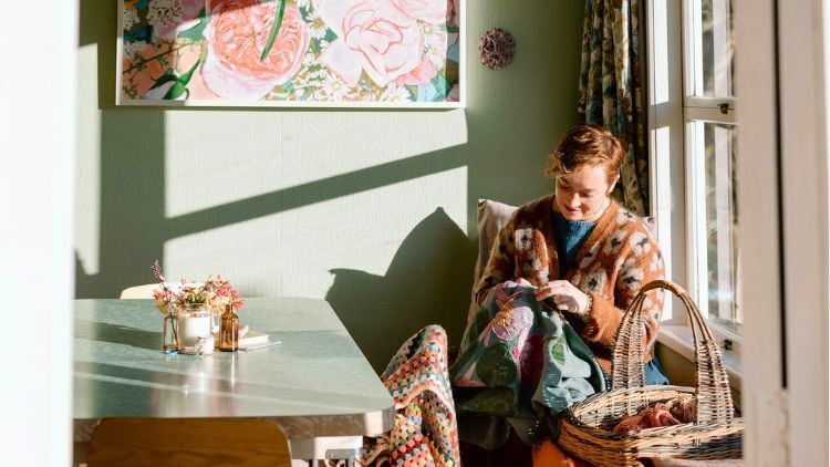 Fleur sitting in a sunny window stitching