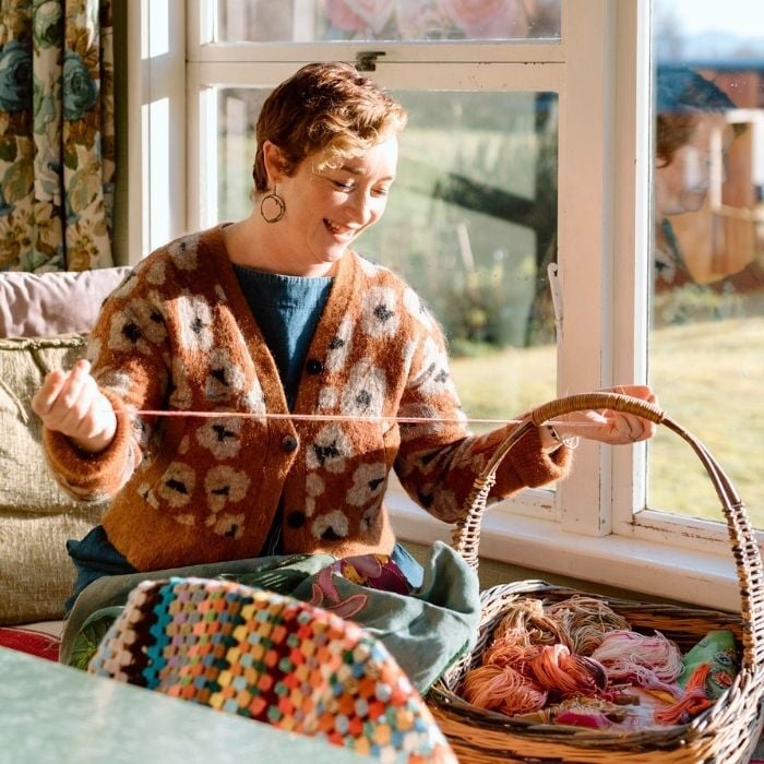 Fleur woods smiling down at yarn