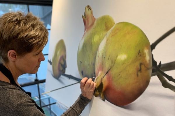 Mardi Busby_ completing the finer details of this ‘Young Pomegranate’ oil painting measuring_ 114H x 140W cm