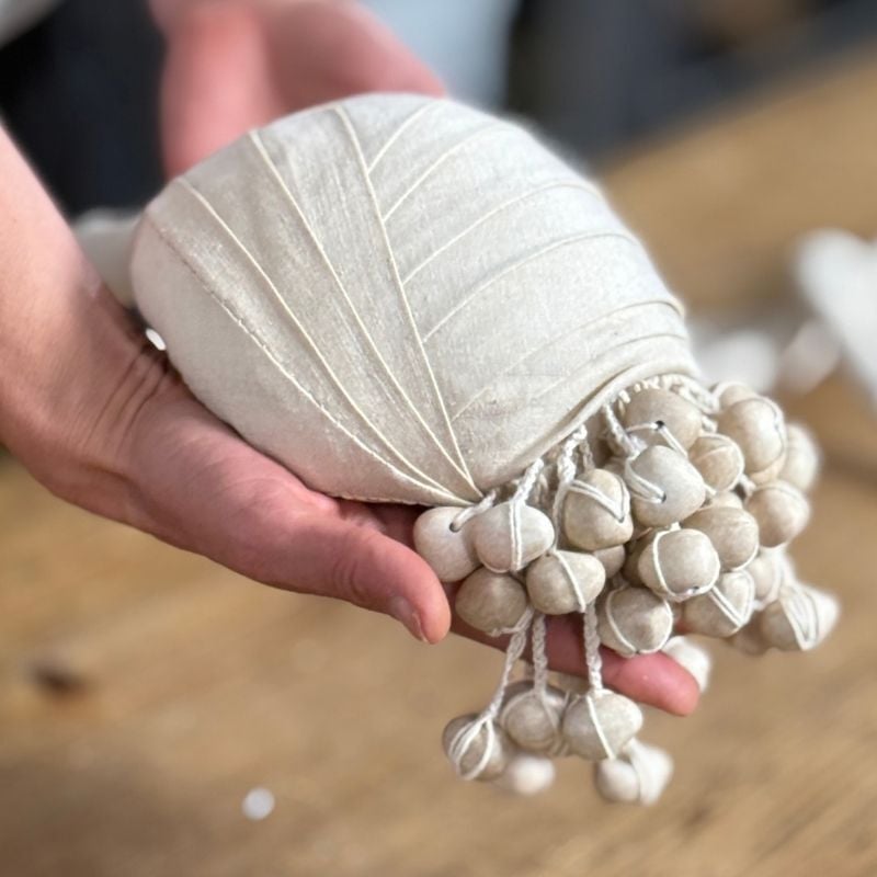 What is an armature, and how is it used in textile sculpture?