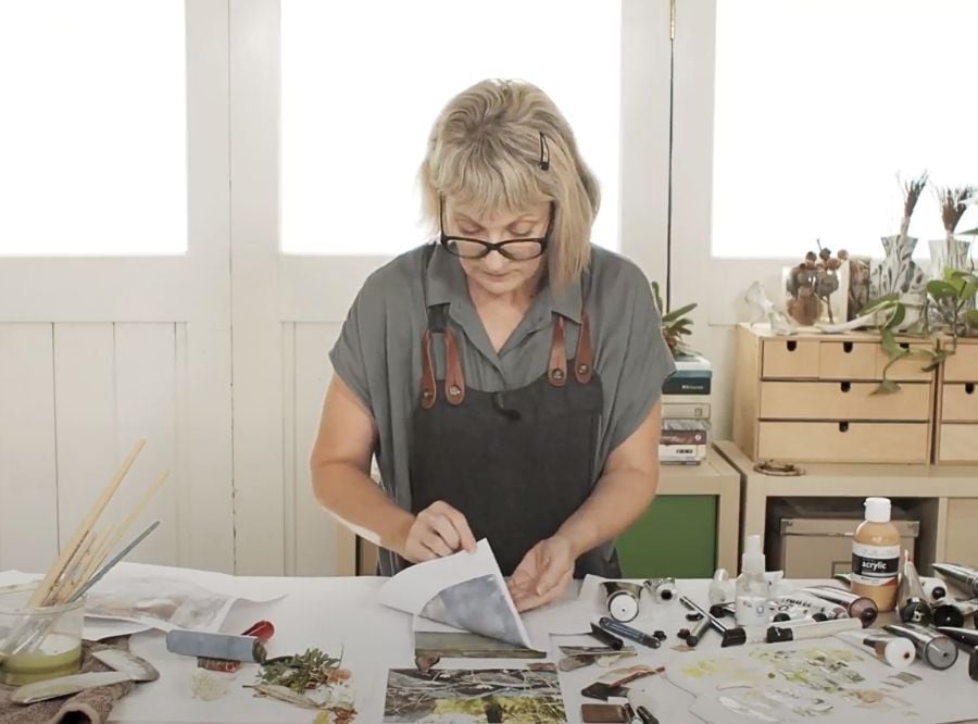 Tara Axford in her studio pulling paper from a gel plate