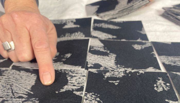 Claire's hand pointing out some detail on an artwork