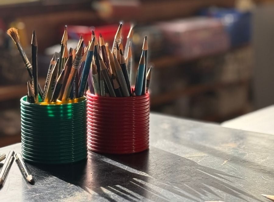 Brushes and pencils in tins