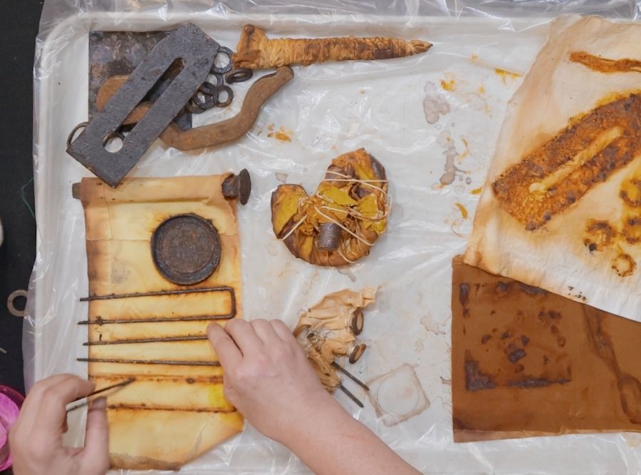 Clarissa's hands as she experiments with rust dyeing
