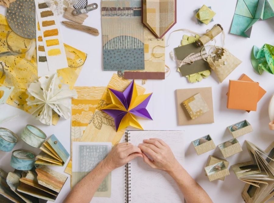 Toni Hartill's hand and art studio table as she works during Unbound