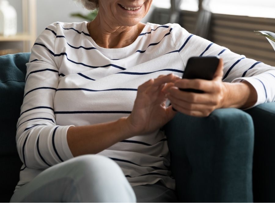 Woman sitting in chair on her mobile phone