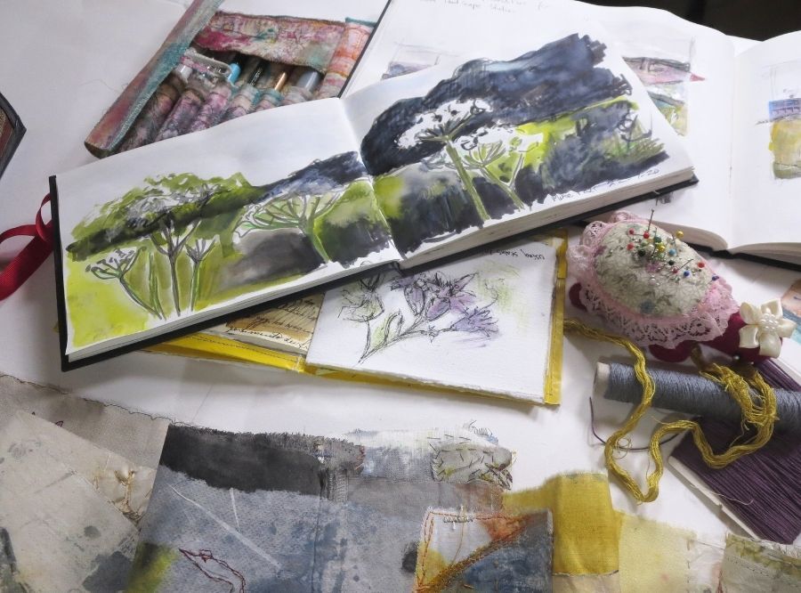 Studio art table with materials and sketchbook