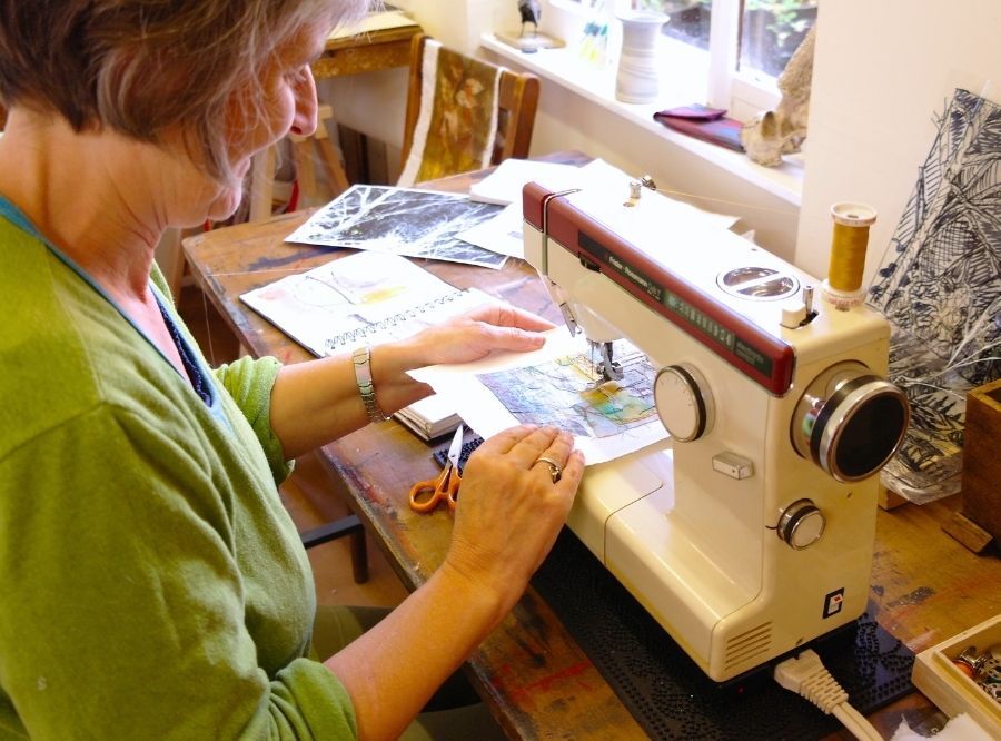 Cas Holmes sitting at her sewing machine