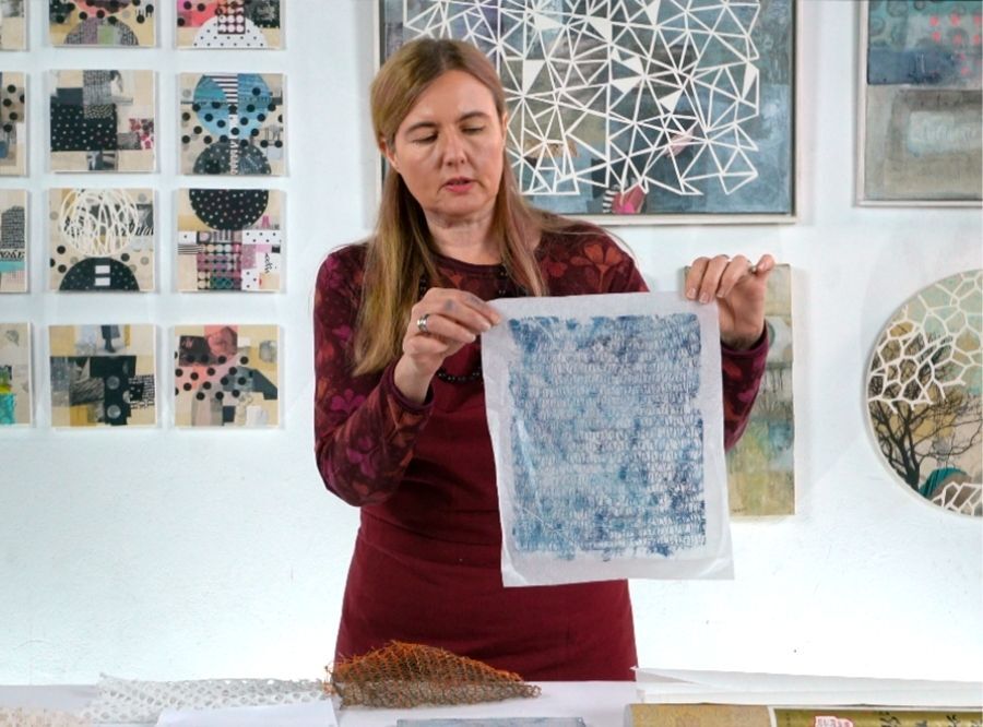 Cordula holding up some collage papers she has created