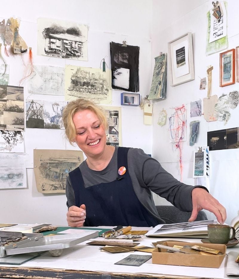 Sally tyrie smiling at her desk