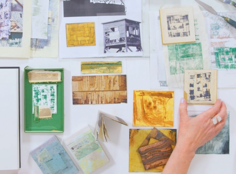Sally's hands going through prints she has made without a press