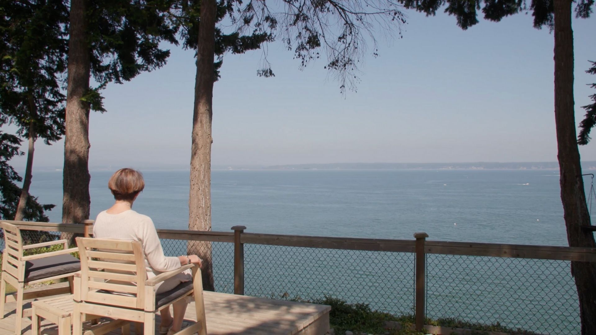 Donna Watson siting in chair facing the water