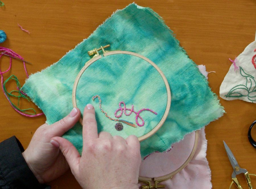 Floor Woods demonstrating an embroidery technique