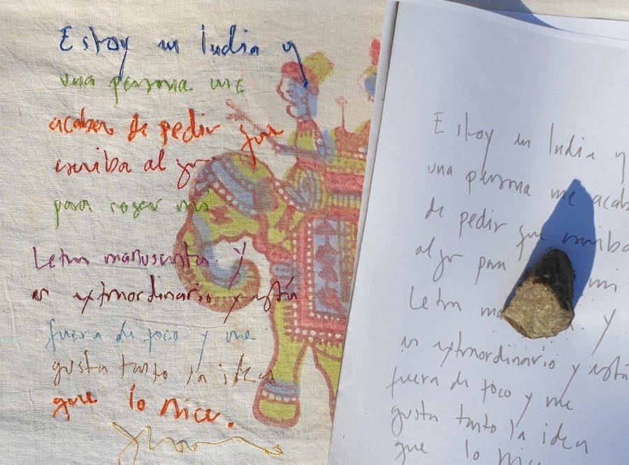 Handwriting on paper alongside cloth that the handwriting has been hand stitched on